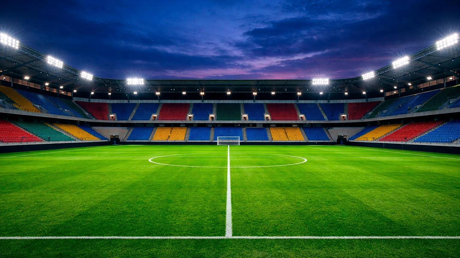 Stade de football professionnel illuminé la nuit avec pelouse verte impeccable